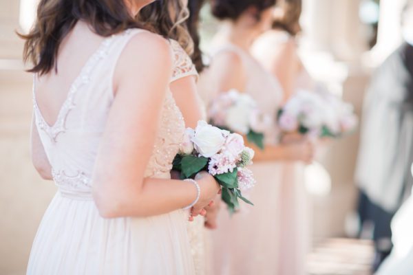 Bridesmaids are holding bouquets in their hands.