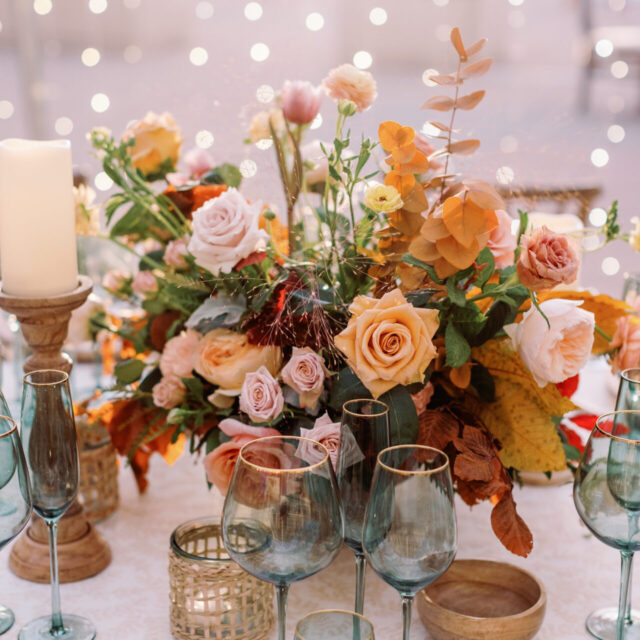 A table setting with flowers and glassware.